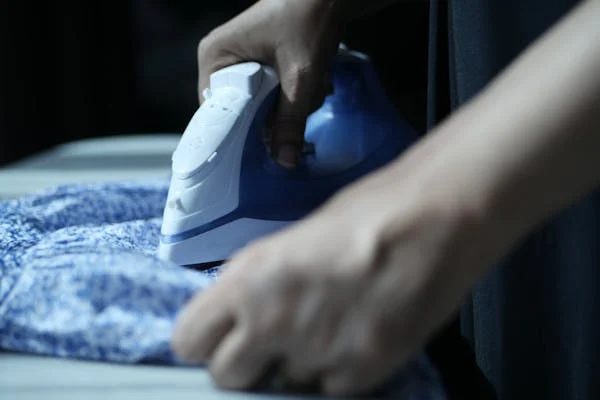 Person ironing clothes